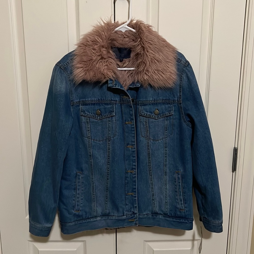A brand new jean jacket with rose pink fur on the collar and inside.